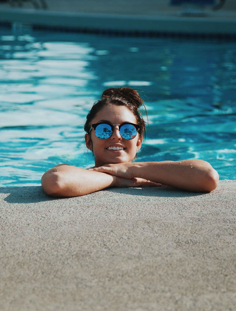 girl smiling by a pool